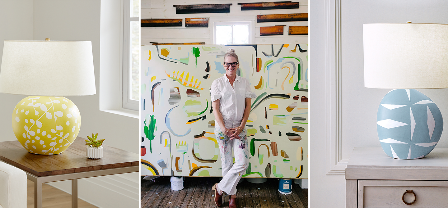 Susan Hable standing in front of her painting, flanked by two lamps she designed