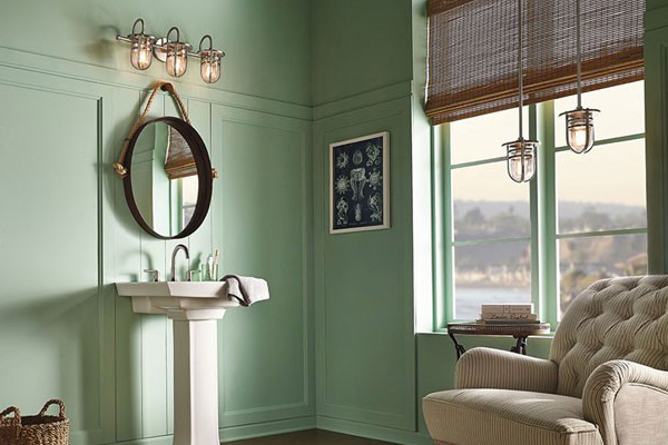 Pictured is a nautical style vanity light in brushed nickel over a mirror.