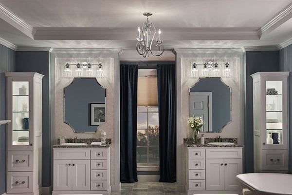Pictured is a metal chandelier in the middle of gray and silver themed powder room.