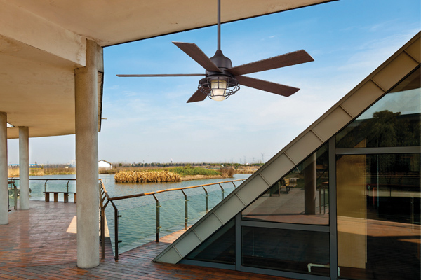 Pictured is a ceiling fan with coastal essence on an outdoor patio over water.