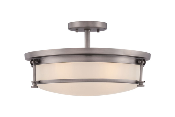 Pictured is a round, metal low profile light with a glass shade.