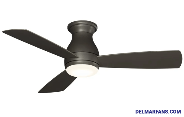 Thee blade oil-rubbed bronze ceiling fan without light installed on the ceiling of a traditional living room with cream-colored brick fireplace.