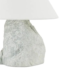 A lamp with a rough stone base